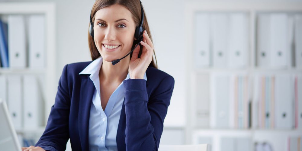 Young businesswoman with headset working in office